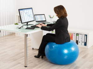 women sits on exercise ball
